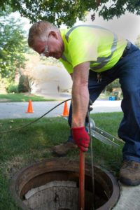 City of Naperville employee, Terald Brue, lowers the camera down a manhole that will inspect the sewer system for cracks and leaks in Naperville on Tuesday, Aug. 13, 2013. | Mike Mantucca / For Sun-Times Media
